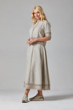 Francoise Top dress Woman wearing a beige outfit Woman wearing a vintage-style dress