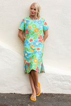 Buy Online Kylie Print Dress Alice Collins Woman wearing a colorful floral dress