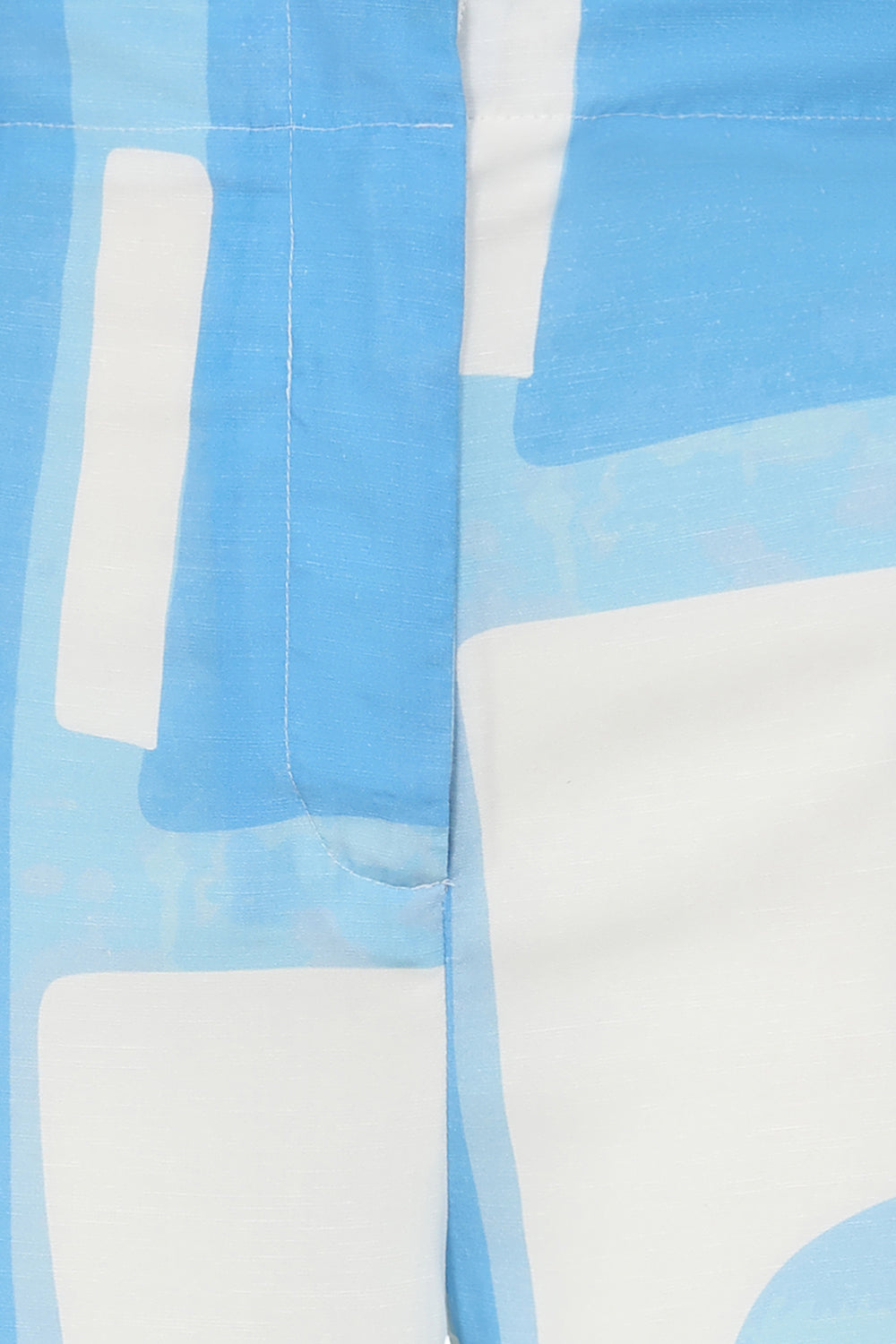 Buy Track Print Trousers Online Alice Collins Close-up of a fabric with blue and white abstract pattern
