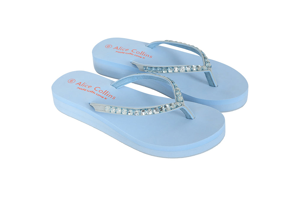 Pair of light blue flip-flops with decorative straps on a white background
